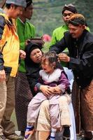 Dieng, Indonesia - August 1, 2015. Dieng Culture Festival, Tourists follow the dreadlocks procession during the Dieng Culture Festival event at Dieng, Banjarnegara district, Central Java photo
