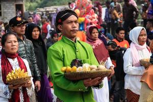 Dieng, Indonesia - August 1, 2015. Dieng Culture Festival, Tourists follow the dreadlocks procession during the Dieng Culture Festival event at Dieng, Banjarnegara district, Central Java photo