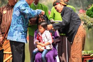 Dieng, Indonesia - August 1, 2015. Dieng Culture Festival, Tourists follow the dreadlocks procession during the Dieng Culture Festival event at Dieng, Banjarnegara district, Central Java photo