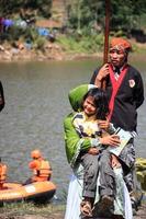 Dieng, Indonesia - August 1, 2015. Dieng Culture Festival, Tourists follow the dreadlocks procession during the Dieng Culture Festival event at Dieng, Banjarnegara district, Central Java photo