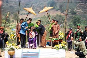 Dieng, Indonesia - August 1, 2015. Dieng Culture Festival, Tourists follow the dreadlocks procession during the Dieng Culture Festival event at Dieng, Banjarnegara district, Central Java photo