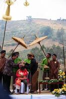 Dieng, Indonesia - August 1, 2015. Dieng Culture Festival, Tourists follow the dreadlocks procession during the Dieng Culture Festival event at Dieng, Banjarnegara district, Central Java photo