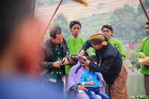 Dieng, Indonesia - August 1, 2015. Dieng Culture Festival, Tourists follow the dreadlocks procession during the Dieng Culture Festival event at Dieng, Banjarnegara district, Central Java photo