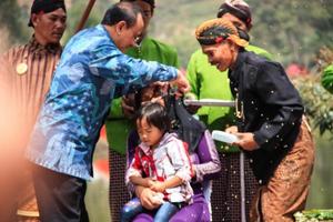 Dieng, Indonesia - August 1, 2015. Dieng Culture Festival, Tourists follow the dreadlocks procession during the Dieng Culture Festival event at Dieng, Banjarnegara district, Central Java photo