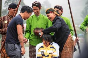 Dieng, Indonesia - August 1, 2015. Dieng Culture Festival, Tourists follow the dreadlocks procession during the Dieng Culture Festival event at Dieng, Banjarnegara district, Central Java photo