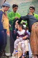 Dieng, Indonesia - August 1, 2015. Dieng Culture Festival, Tourists follow the dreadlocks procession during the Dieng Culture Festival event at Dieng, Banjarnegara district, Central Java photo