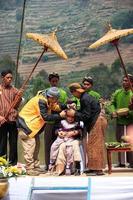 Dieng, Indonesia - August 1, 2015. Dieng Culture Festival, Tourists follow the dreadlocks procession during the Dieng Culture Festival event at Dieng, Banjarnegara district, Central Java photo