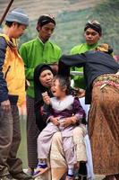 Dieng, Indonesia - August 1, 2015. Dieng Culture Festival, Tourists follow the dreadlocks procession during the Dieng Culture Festival event at Dieng, Banjarnegara district, Central Java photo