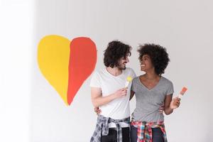 couple with painted heart on wall photo