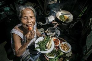 Senior woman chef cooks in the kitchen photo