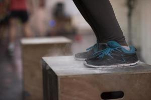 mujer negra está realizando saltos de caja en el gimnasio foto