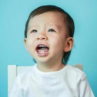 Portrait of sad crying baby girl on white photo