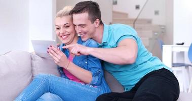 couple relaxing at  home with tablet computers photo