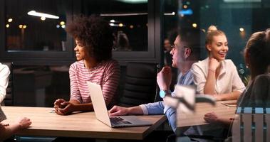 Multiethnic startup business team in night office photo