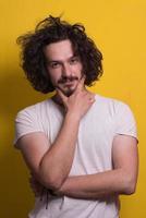 young man with funny hair over color background photo