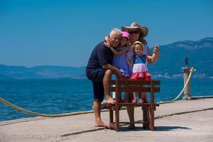 portrait of grandparents and granddaughters by the sea photo