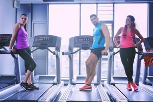 Group of people running on treadmills photo