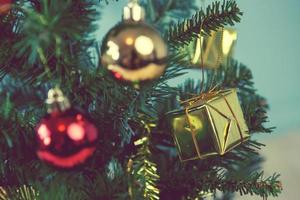 Christmas tree with gifts on green background on blurred, vintage color style photo
