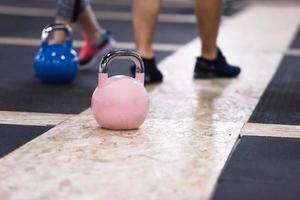 athletes doing exercises with kettlebells photo