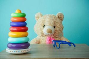 Conceptual shot of child education. Brown teddy bear playing with building blocks photo