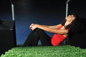 young woman relax on green stairs with grass surface photo