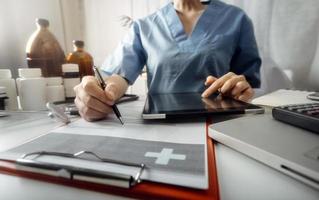 Medicine doctor and stethoscope touching icon medical network connection with modern interface on digital tablet in hospital background. Medical technology network concept photo