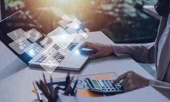 Big data analytics and business intelligence concept with chart and graph icons on a digital screen interface and a businessman hand in background photo