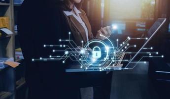Cybersecurity and privacy concepts to protect data. Lock icon and internet network security technology. Businessman protecting personal data on smart phone with virtual screen interfaces. photo