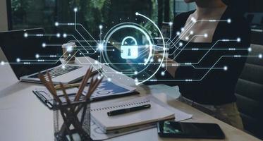 Cybersecurity and privacy concepts to protect data. Lock icon and internet network security technology. Businessman protecting personal data on smart phone with virtual screen interfaces. photo