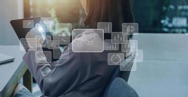 Big data analytics and business intelligence concept with chart and graph icons on a digital screen interface and a businessman hand in background photo
