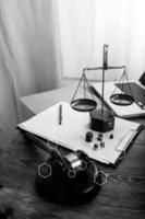 Business and lawyers discussing contract papers with brass scale on desk in office. Law, legal services, advice, justice and law concept picture with film grain effect photo