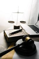 justice and law concept.Male judge in a courtroom on wooden table and Counselor or Male lawyer working in office. Legal law, advice and justice concept. photo