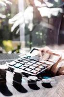 Business accounting concept, Business man using calculator with computer laptop, budget and loan paper in office. photo