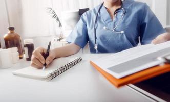 Medicine doctor and stethoscope touching icon medical network connection with modern interface on digital tablet in hospital background. Medical technology network concept photo