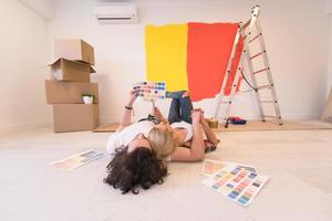 Happy young couple relaxing after painting photo