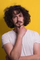 young man with funny hair over color background photo