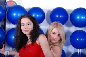 two happy girls in fitness studio photo