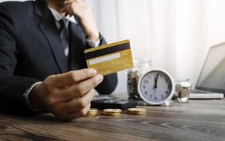 technology, people and online shopping concept - happy smiling man with tablet pc computer and credit card at home photo