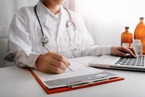 Medicine doctor and stethoscope touching icon medical network connection with modern interface on digital tablet in hospital background. Medical technology network concept photo