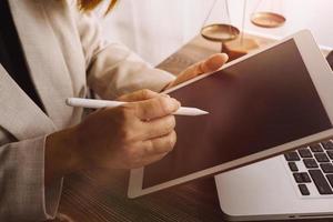 Business and lawyers discussing contract papers with brass scale on desk in office. Law, legal services, advice, justice and law concept picture with film grain effect photo