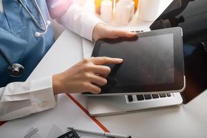 Medicine doctor and stethoscope touching icon medical network connection with modern interface on digital tablet in hospital background. Medical technology network concept photo