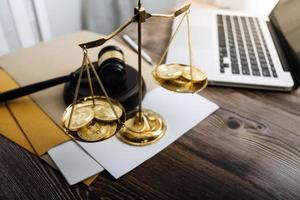 Business and lawyers discussing contract papers with brass scale on desk in office. Law, legal services, advice, justice and law concept picture with film grain effect photo