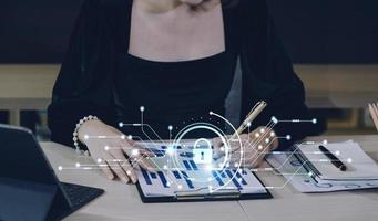 Cybersecurity and privacy concepts to protect data. Lock icon and internet network security technology. Businessman protecting personal data on smart phone with virtual screen interfaces. photo