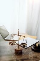 Justice and law concept.Male judge in a courtroom with the gavel, working with, computer and docking keyboard, eyeglasses, on table in morning light photo