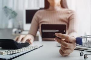 tecnología, personas y concepto de compras en línea - hombre sonriente feliz con computadora de tablet pc y tarjeta de crédito en casa foto