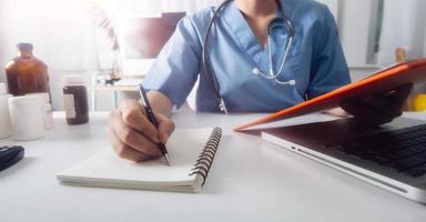 Medicine doctor and stethoscope touching icon medical network connection with modern interface on digital tablet in hospital background. Medical technology network concept photo