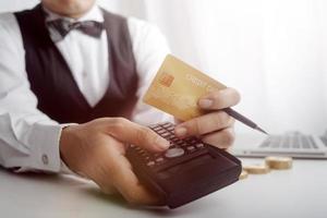 technology, people and online shopping concept - happy smiling man with tablet pc computer and credit card at home photo