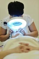 woman with facial mask in cosmetic studio photo