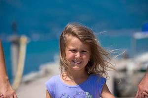 young happy family walking by the sea photo