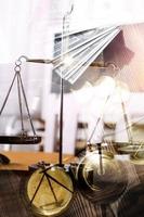 Justice and law concept.Male judge in a courtroom with the gavel, working with, computer and docking keyboard, eyeglasses, on table in morning light photo